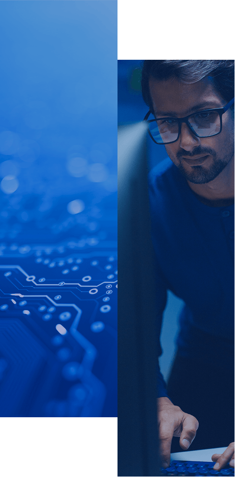 A man wearing glasses works on a computer, with a blue-toned close-up of a circuit board on the left side of the image, conveying a technology or IT theme.