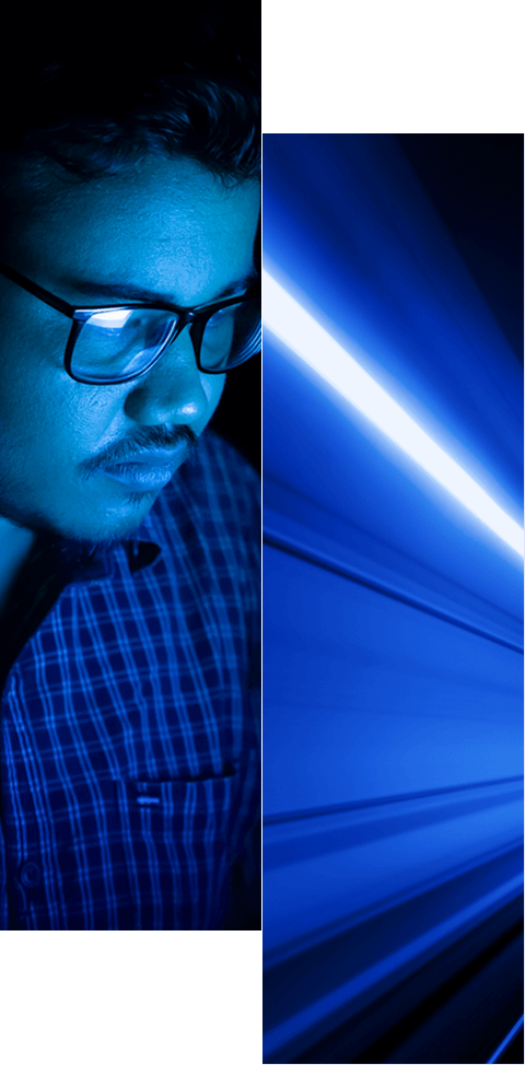 A man wearing glasses, illuminated by blue light, is on the left; on the right, blue light streaks suggest speed or motion—visually reflecting how our identity data platform improves governance and compliance. Both halves are split by a vertical white line.