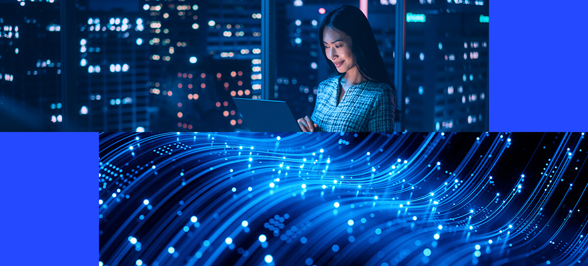 A woman using a laptop at night in a city, above a digital graphic of flowing blue lines and glowing dots representing data or technology, highlights the importance of identity observability in today’s connected world.