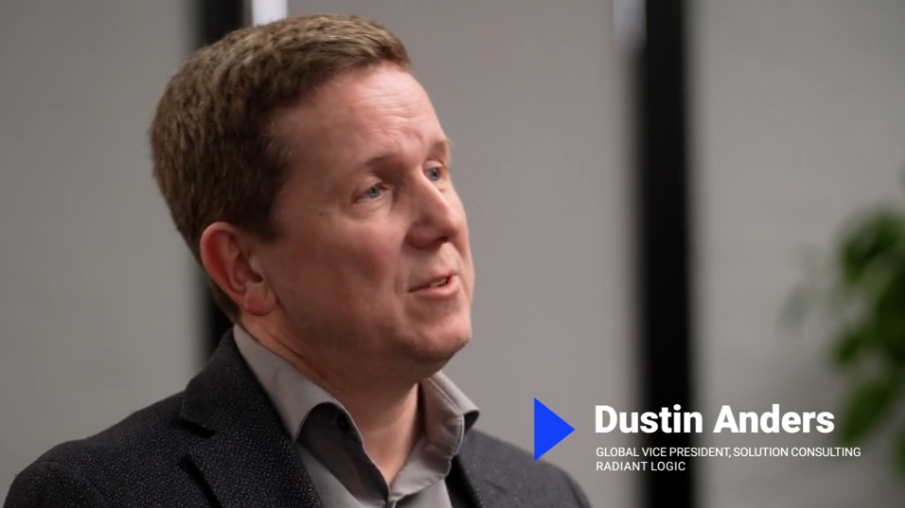 A man in a suit speaks in an office setting. Text on the image reads: Dustin Anders, Global Vice President, Solution Consulting, Radiant Logic.