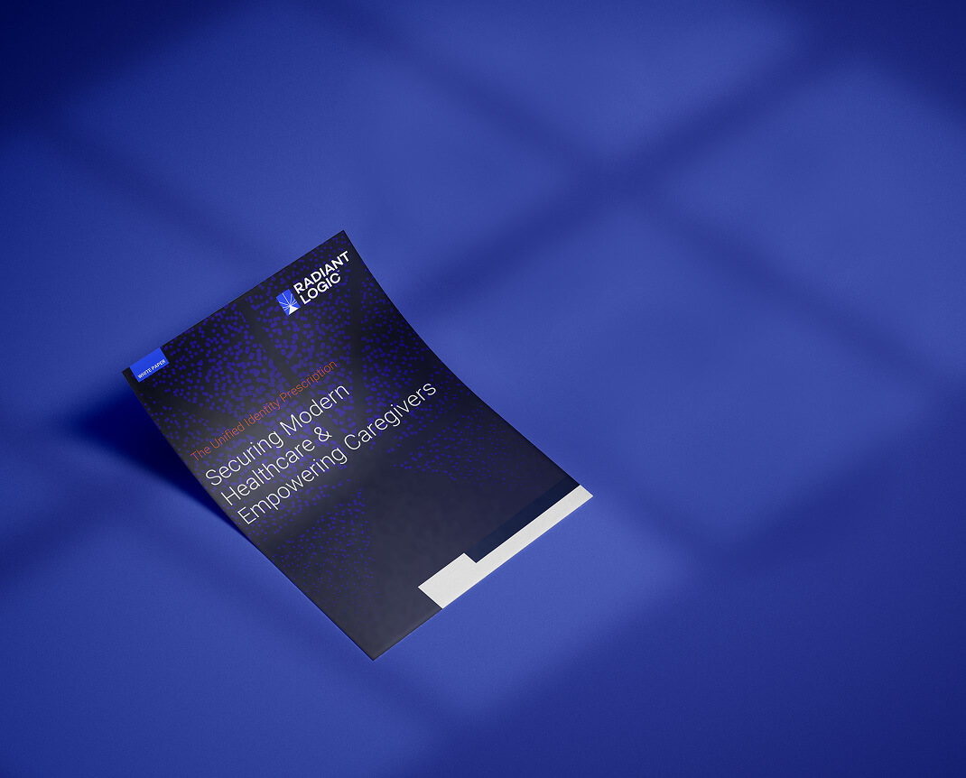 A brochure titled Securing Modern Healthcare & Empowering Caregivers lies on a blue surface, with the Radiant Logic logo visible at the top left corner and light casting shadow patterns across the background.