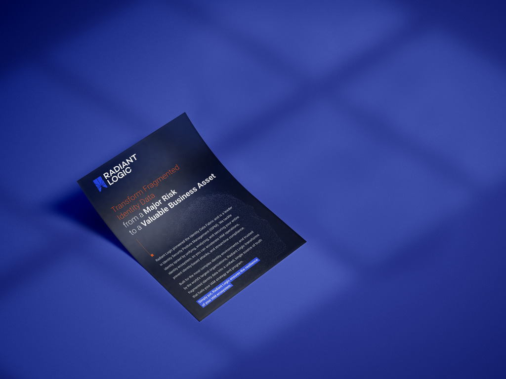 A single-page flyer with the Radiant Logic logo lies on a smooth blue surface. The flyer features bold and colored text highlighting transforming identity data into a valuable business asset, with a paragraph of smaller text below.