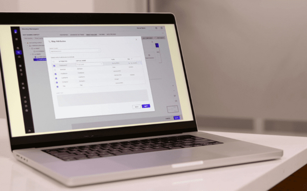 A laptop on a white desk displays a software interface with a pop-up window showing a table of data fields and options to cancel or save changes. The background is out of focus.
