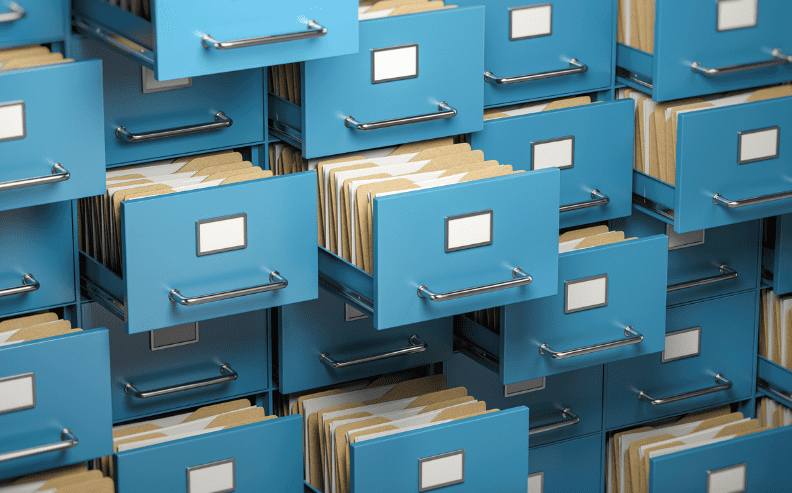Rows of blue file cabinet drawers, some open and some closed, revealing organized folders and blank white labels on the front of each drawer.