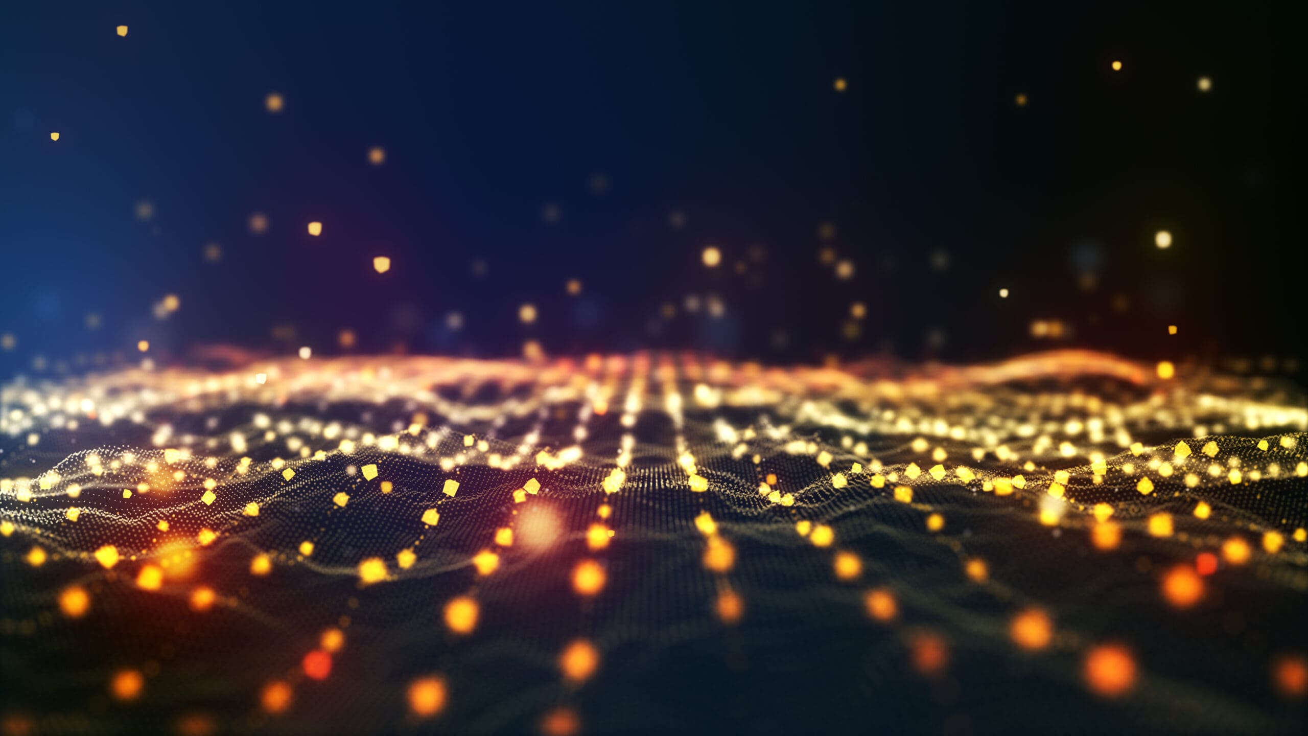 A digital abstract image shows a glowing grid of orange and yellow light dots on a dark background, resembling a futuristic landscape or data network, with scattered lights creating a sense of depth and motion.