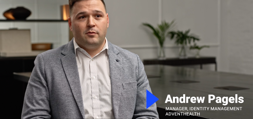 A man in a gray jacket and white shirt sits in a modern office. Text on the image reads: “Andrew Pagels, Manager, Identity Management, AdventHealth.” There are plants and a table in the background.