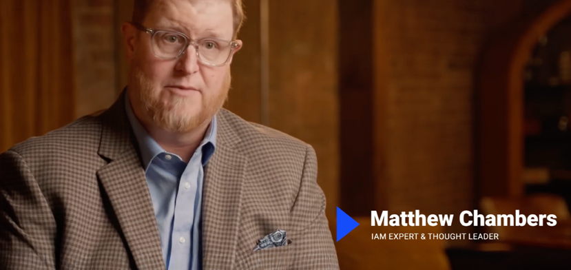 A man with glasses and a beard, wearing a checked blazer and blue shirt, sits indoors. Text on the image reads: Matthew Chambers, IAM Expert & Thought Leader.