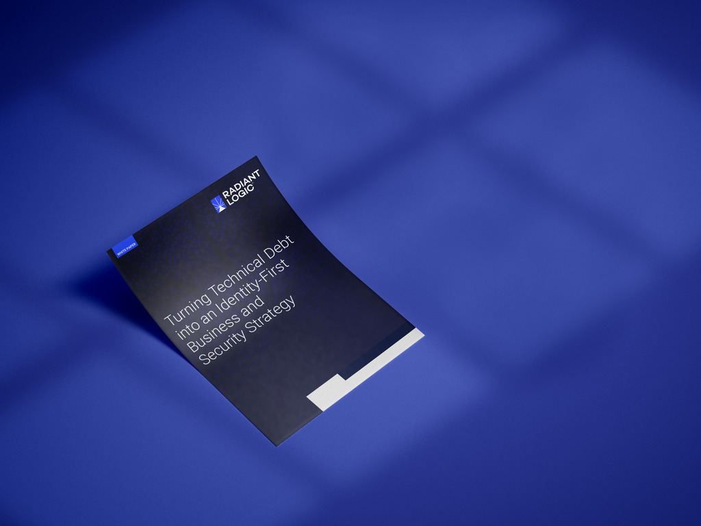 A dark booklet titled Turning Technical Debt into an Identity-First Business and Security Strategy sits on a blue surface under soft shadowed light. The Radiant Logic logo is visible at the top left corner.